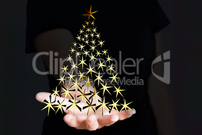 Hand holding Christmas tree made of stars