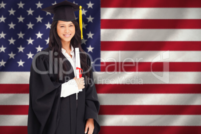 Composite image of a smiling woman holding her degree as she has