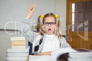 Pupil sitting at her desk and having a question