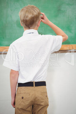 Puzzled student looking at blackboard