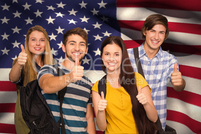 Composite image of happy students gesturing thumbs up at college