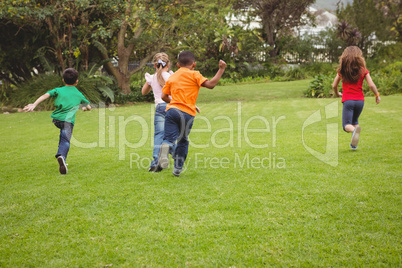 Happy kids running across the grass