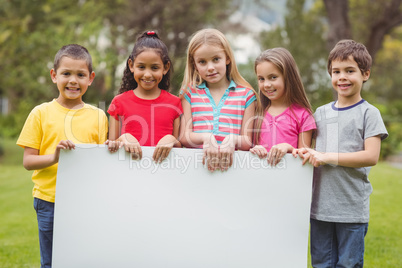 Cute pupils showing large poster