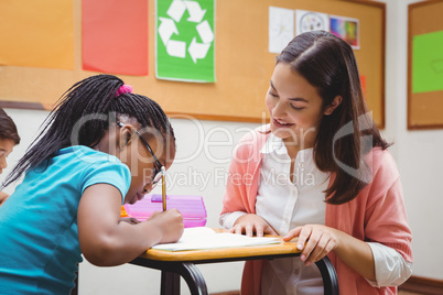 Happy teacher helping her students