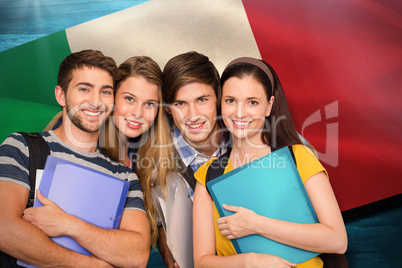 Composite image of happy students holding folders at college cor