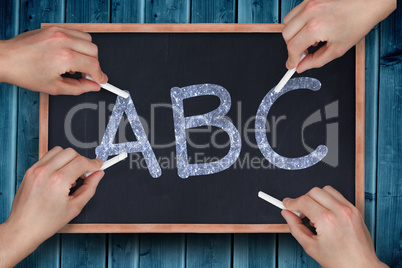 Composite image of multiple hands writing with chalk