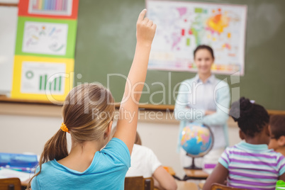 Pupil raising hand in classroom