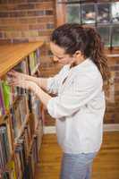 Librarian sorting books on the shelves