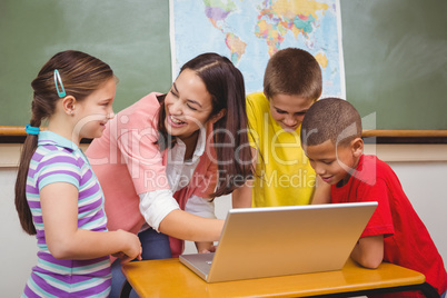 Students and teacher using a laptop