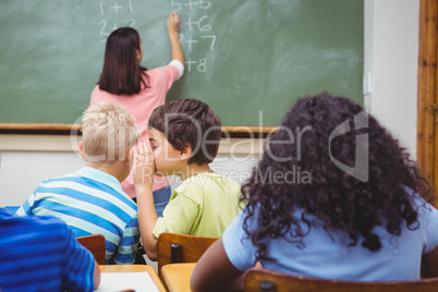 Student whispering into another students ear