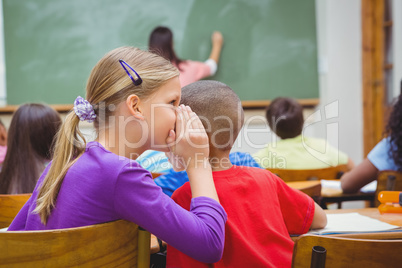Student whispering into another students ear