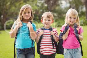 Smiling classmates with schoolbags