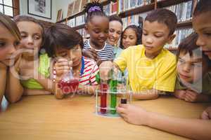 Pupils and teacher doing science in library