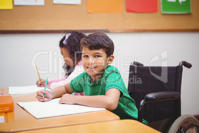 Smiling student sitting in wheelchair