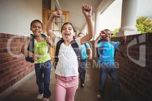Happy pupils running around the corridor