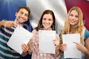 Composite image of smiling students showing their exams
