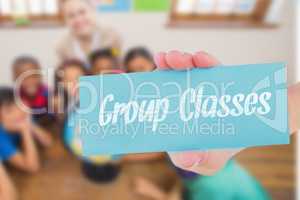 Group classes against cute pupils and teacher in classroom with