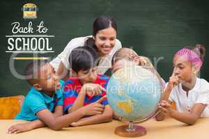 Composite image of cute pupils and teacher looking at globe in l