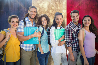 Composite image of smiling group of students standing in a row