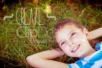 Create against cute little girl lying on grass