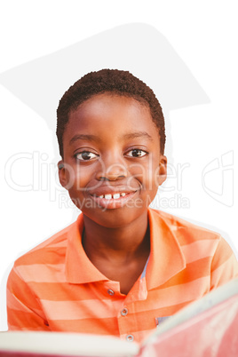 Composite image of cute boy reading book in library