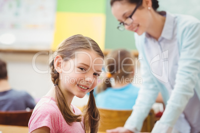 Teacher helping a pupil during class