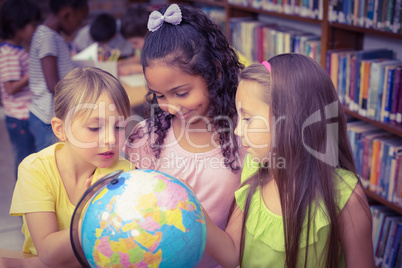 Pupils in library with globe