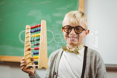 Smiling pupil dressed up as teacher holding abacus