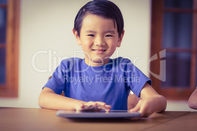 Cute pupil in class using tablet pc