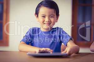 Cute pupil in class using tablet pc