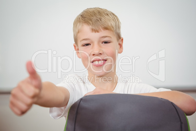 Smiling student giving a thumbs up