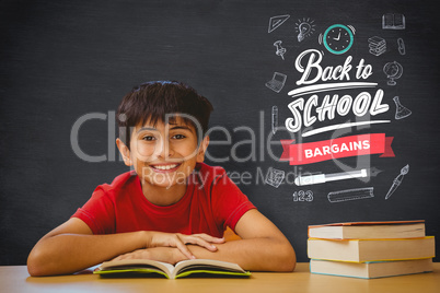 Composite image of cute boy reading book in library