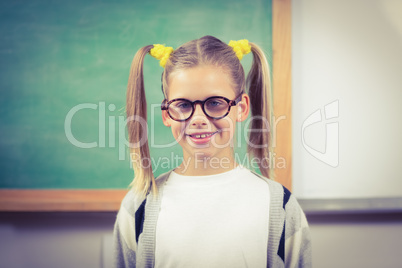 Cute pupil standing in front of chalkboard