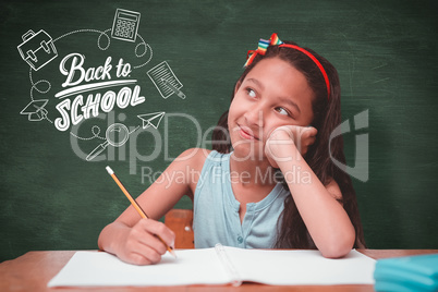 Composite image of cute pupil at desk