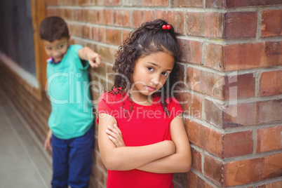 Upset child being teased by another child