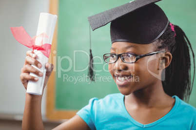 Smiling pupil with mortar board and diploma