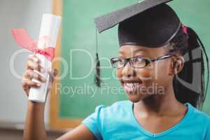 Smiling pupil with mortar board and diploma