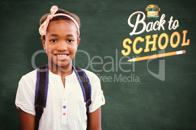 Composite image of little girl smiling in school corridor