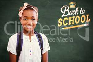 Composite image of little girl smiling in school corridor