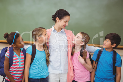 Teacher and pupils smiling in classroom