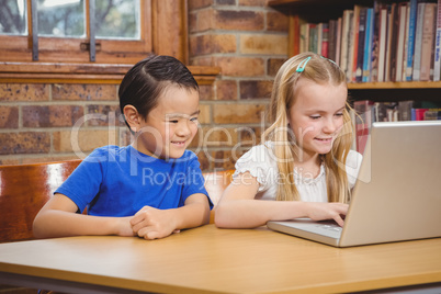 Students using a laptop at their desk Students using a laptop at their desk