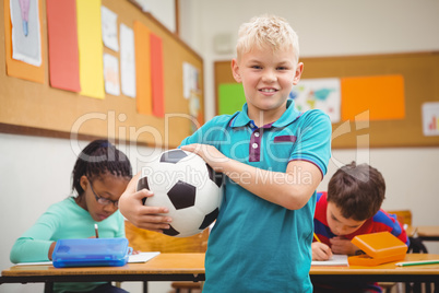 Smiling student holding a football