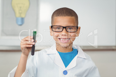 Smiling pupil with lab coat holding test tube