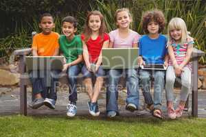Kids sitting on a park bench