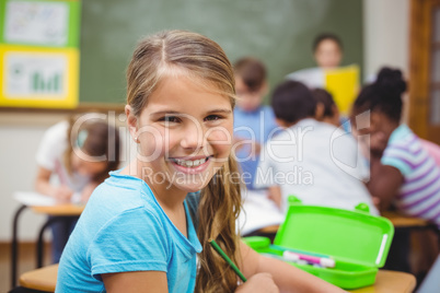 Pupil smiling at camera in classroom