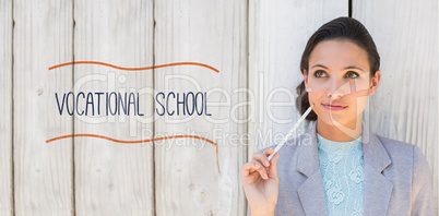 Vocational school against stylish brunette thinking and smiling