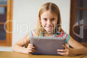 Cute pupil in class using tablet pc