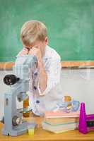 Student using a microscope and chemistry set