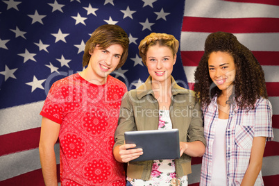 Composite image of college students using digital tablet in libr