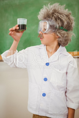 Student dressed up as einstein holding a beaker